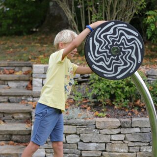 Cyclone Outdoor Music Instrument (young boy playing; view 1)