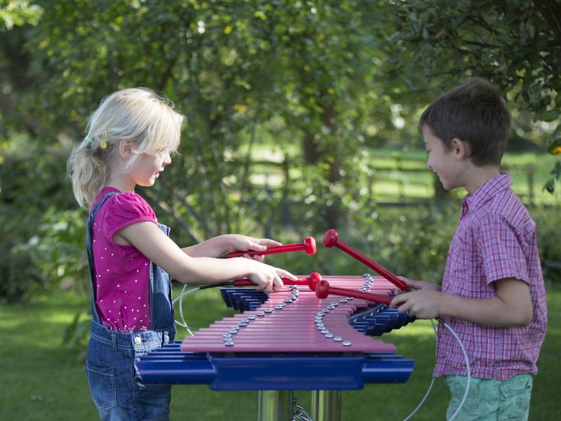 Duo Outdoor Music Instrument (2 girls playing; side view)