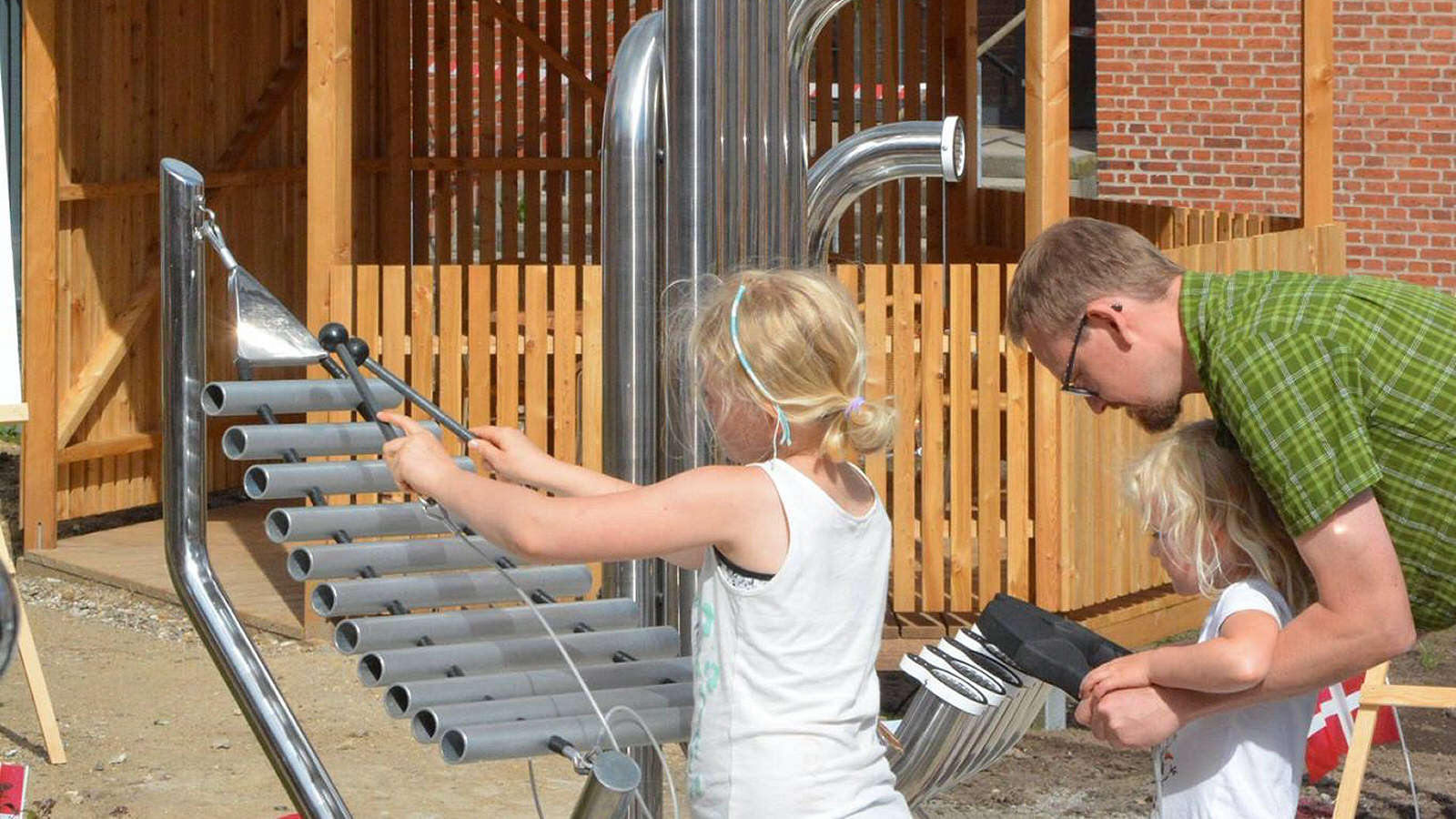 Pentatonic Tembos Outdoor Music Instrument (2 young girls and father playing)