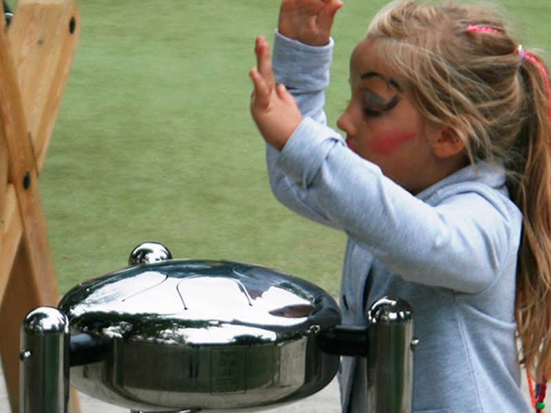Percussion Play Babel Drum (small; young girl with face paint playing)
