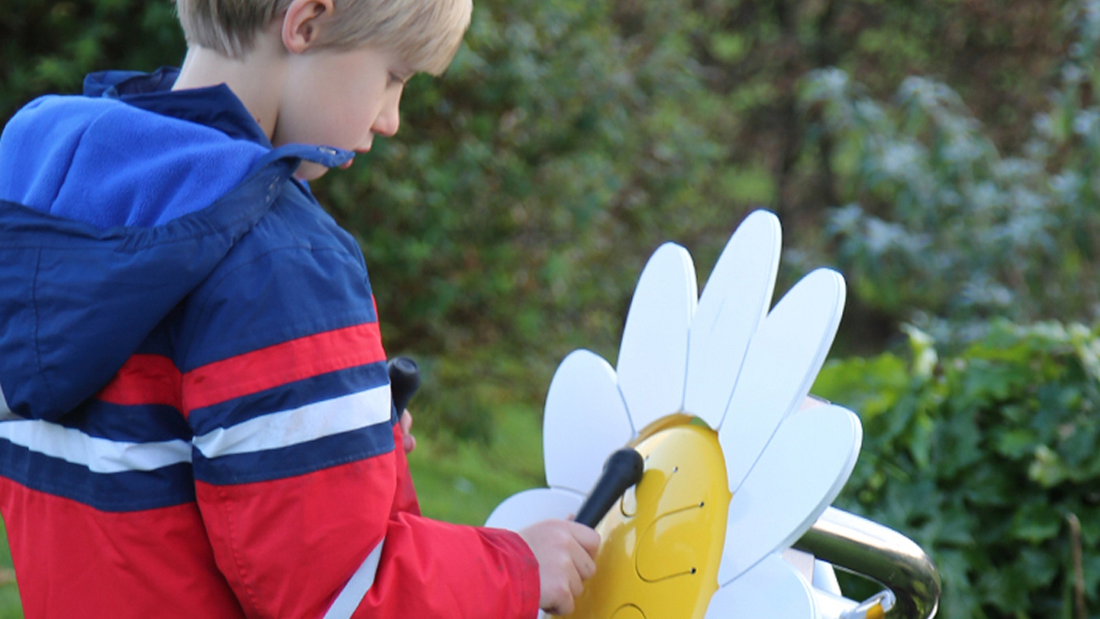 Percussion Play Daisy Petal Drum (young boy playing)