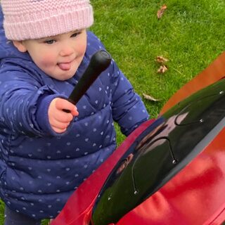 Percussion Play Poppy Petal Drum (small child playing; top view)