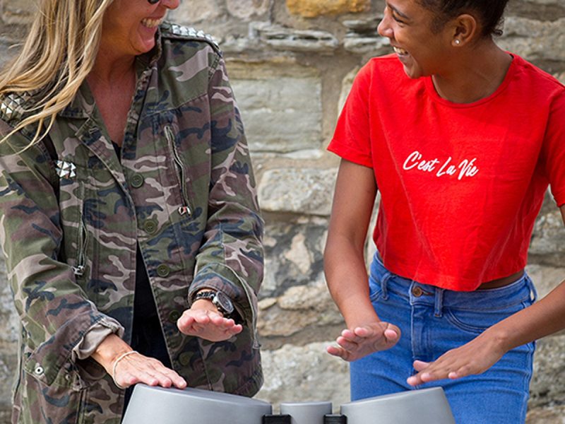 Percussion Play Tumbadoras (older woman and young woman playing)