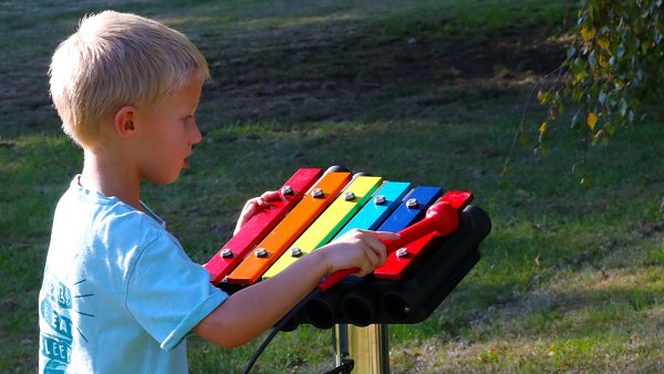 Rainbow Metallophone Outdoor Music Instrument (1 boy playing; right side view)