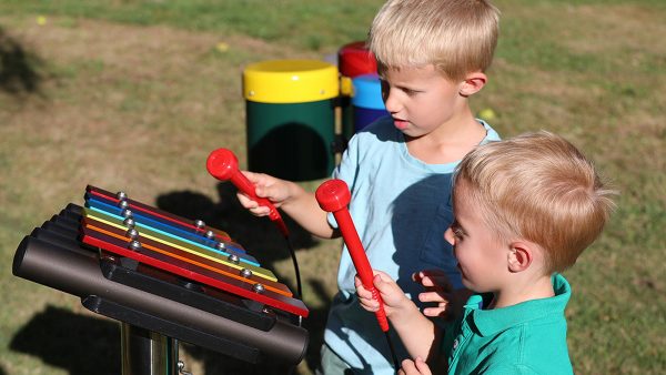 Rainbow Metallophone Outdoor Music Instrument (2 boys playing; left side view)