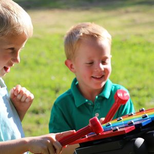 Rainbow Metallophone Outdoor Music Instrument (2 boys playing; right side view)