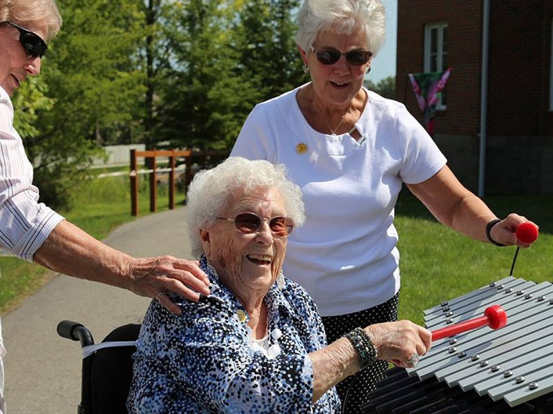 Sansa Rimba Outdoor Music Instrument (older woman playing with friends)