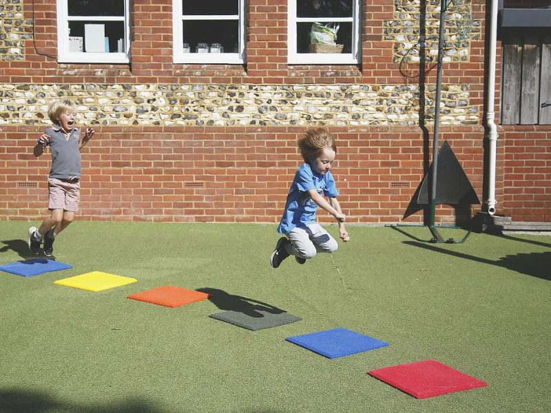Stepping Stones Outdoor Music Instrument (2 boys jumping)