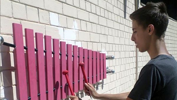 Wall Marimba Outdoor Music Instrument (teenage boy playing)