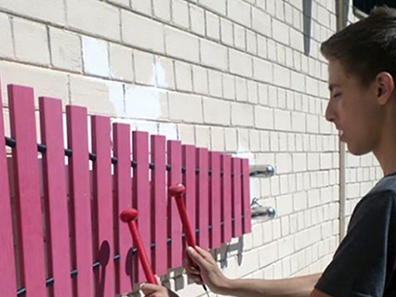 Wall Marimba Outdoor Music Instrument (teenage boy playing)