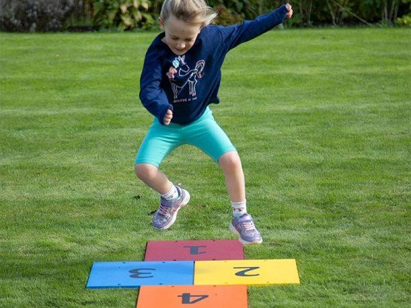 Harmony Hop Outdoor Music Instrument (young girl jumping)