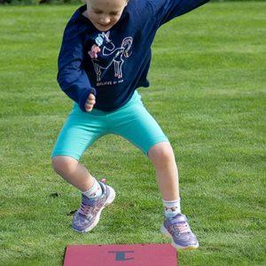 Harmony Hop Outdoor Music Instrument (young girl jumping)