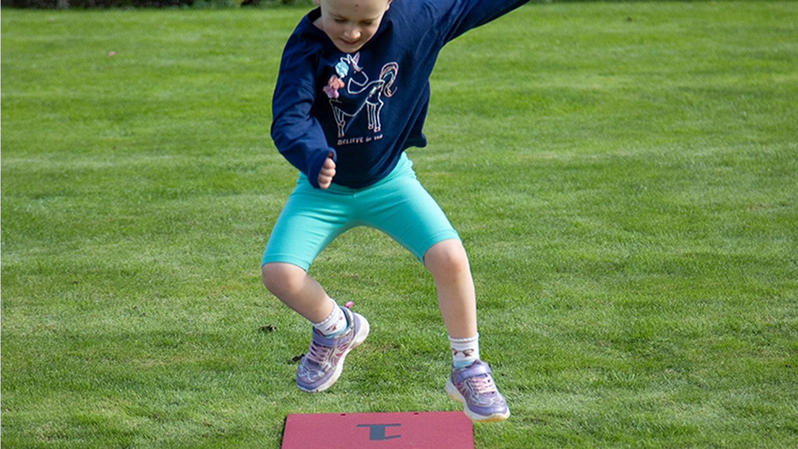 Harmony Hop Outdoor Music Instrument (young girl jumping)